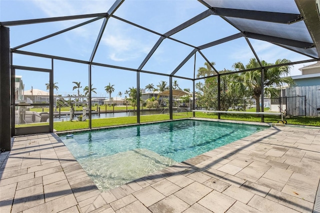 view of pool featuring a lanai, a patio, and a water view