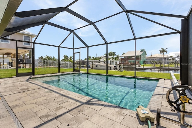 view of pool with a water view, a patio, a yard, and glass enclosure