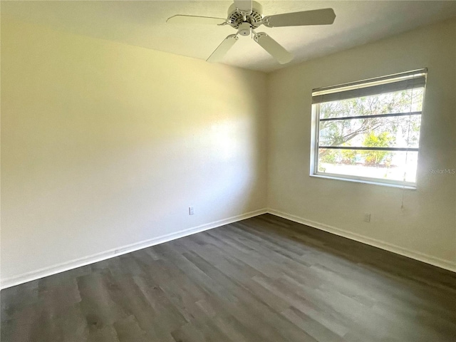 unfurnished room with ceiling fan and dark wood-type flooring