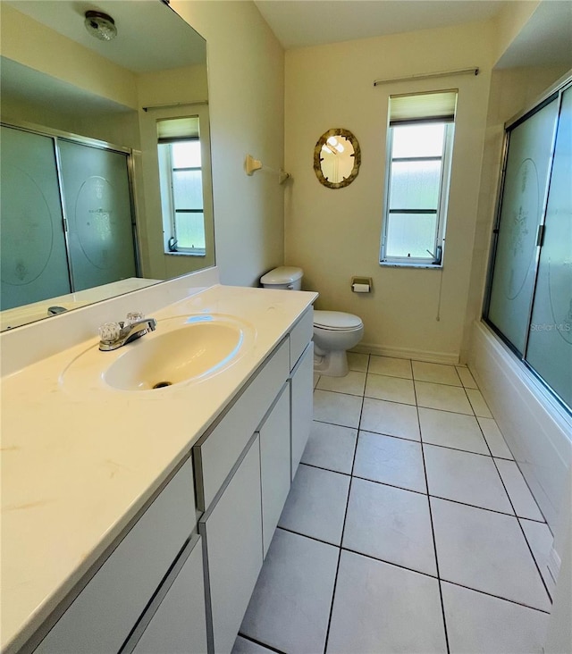 full bathroom with tile patterned flooring, vanity, toilet, and bath / shower combo with glass door