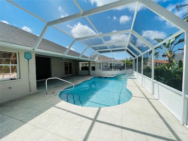 view of swimming pool with a lanai and a patio area