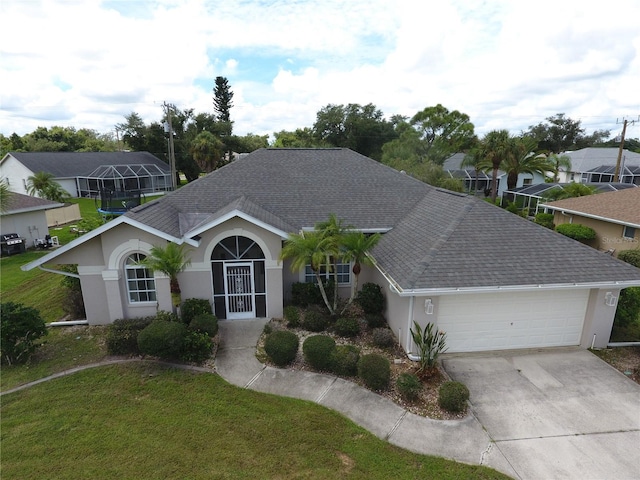 ranch-style home with a garage and a front lawn