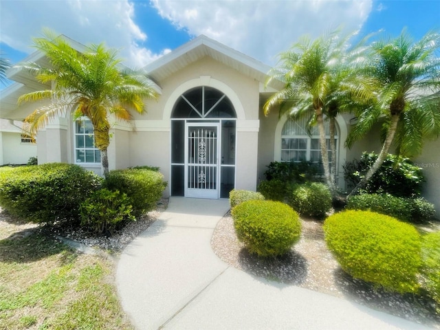 515 Allworthy St, Port Charlotte, FL 33954 - view of exterior entry featuring stucco siding