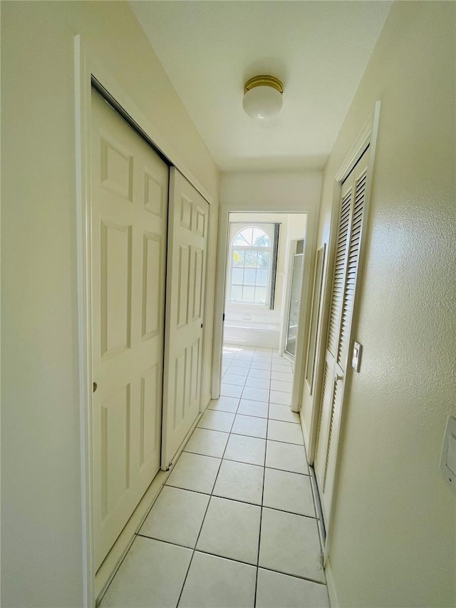 hallway with light tile patterned floors