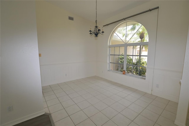 515 Allworthy St, Port Charlotte, FL 33954 - unfurnished dining area featuring a chandelier, a decorative wall, wainscoting, and visible vents