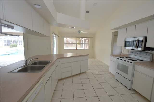 515 Allworthy St, Port Charlotte, FL 33954 - kitchen with ceiling fan, white appliances, vaulted ceiling, light countertops, and a sink