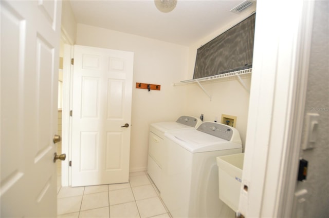 515 Allworthy St, Port Charlotte, FL 33954 - laundry area featuring separate washer and dryer, light tile patterned flooring, visible vents, laundry area, and a sink