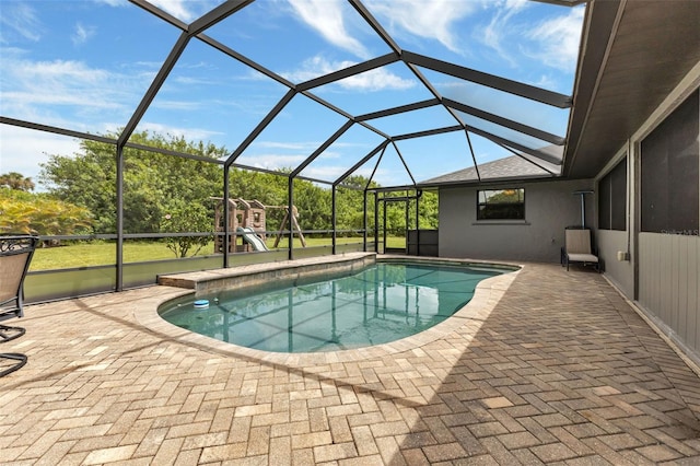 view of swimming pool featuring a playground, a lanai, and a patio area