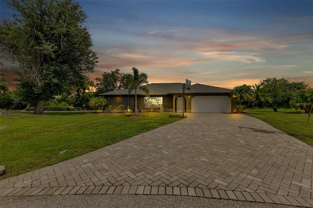 view of front of house featuring a lawn and a garage