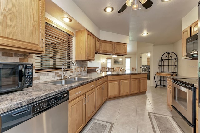 kitchen with sink, light tile patterned flooring, decorative backsplash, and appliances with stainless steel finishes