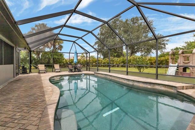 view of pool with a lanai and a patio