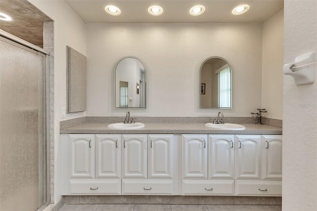 bathroom with vanity, an enclosed shower, and tile patterned flooring