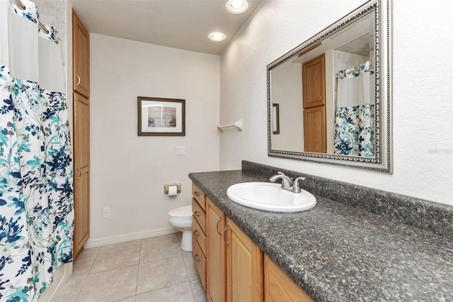 bathroom with vanity, toilet, and tile patterned floors