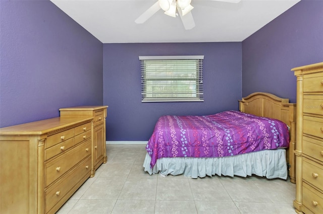 tiled bedroom featuring ceiling fan