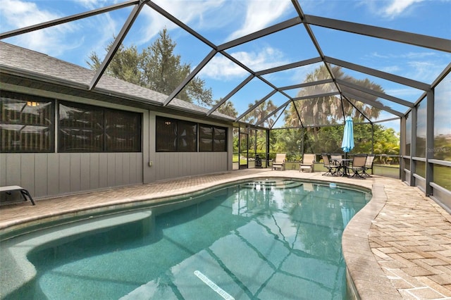 view of swimming pool with a patio area and a lanai