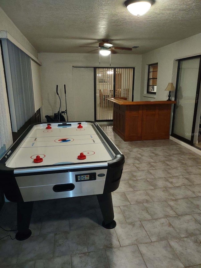 game room featuring a textured ceiling