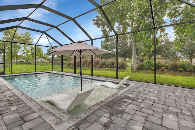 view of swimming pool with a patio, glass enclosure, and a lawn