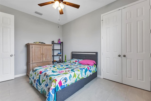 16195 Maya Cir, Punta Gorda, FL 33955 - bedroom with light tile patterned flooring, a closet, a ceiling fan, and baseboards