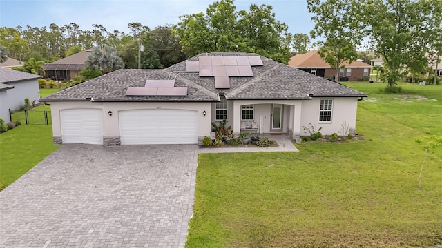 16195 Maya Cir, Punta Gorda, FL 33955 - view of front of property with stucco siding, an attached garage, decorative driveway, solar panels, and roof with shingles