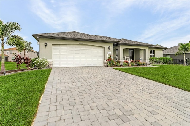 view of front of property featuring a garage and a front lawn