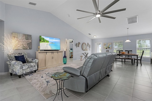 tiled living room with high vaulted ceiling and ceiling fan