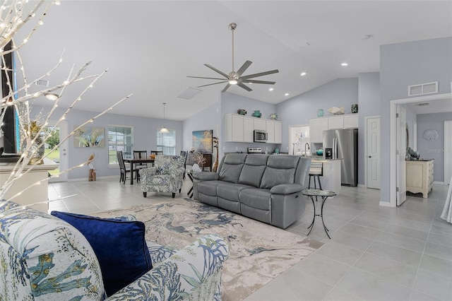 tiled living room with high vaulted ceiling, sink, and ceiling fan