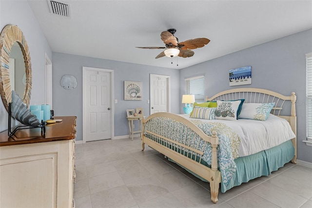 tiled bedroom with ceiling fan