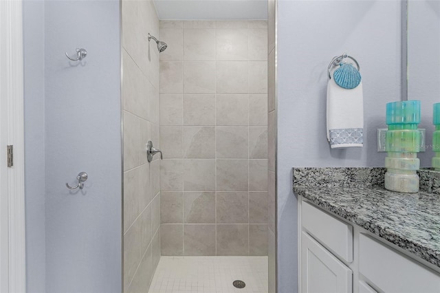 bathroom featuring vanity and a tile shower