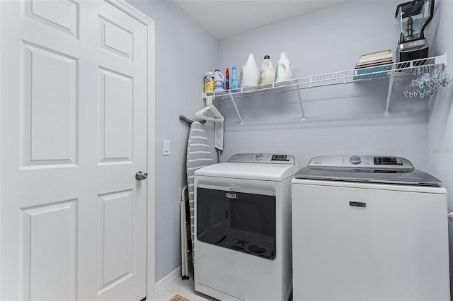 clothes washing area with independent washer and dryer