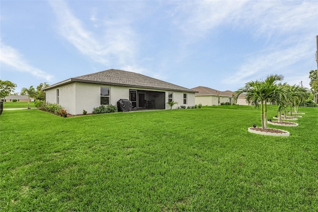 rear view of property featuring a yard