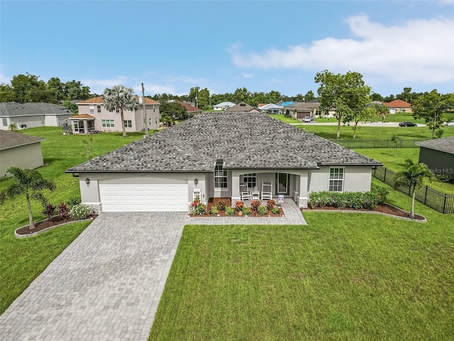 ranch-style house featuring a garage and a front yard