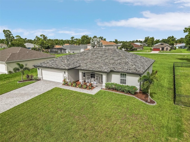 ranch-style home featuring a garage and a front lawn