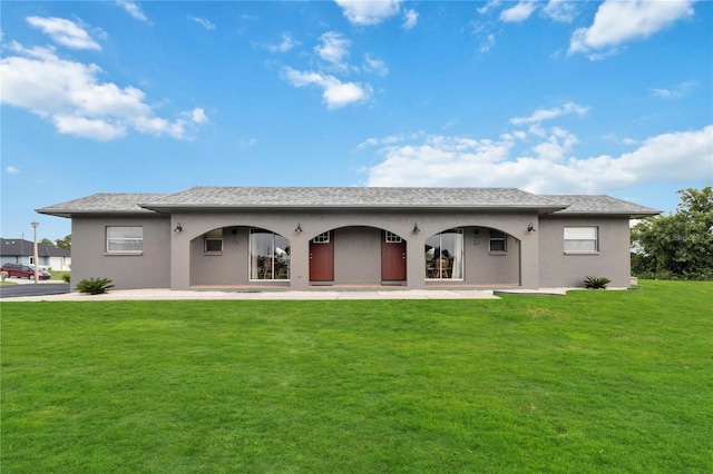 back of property featuring a yard and a patio