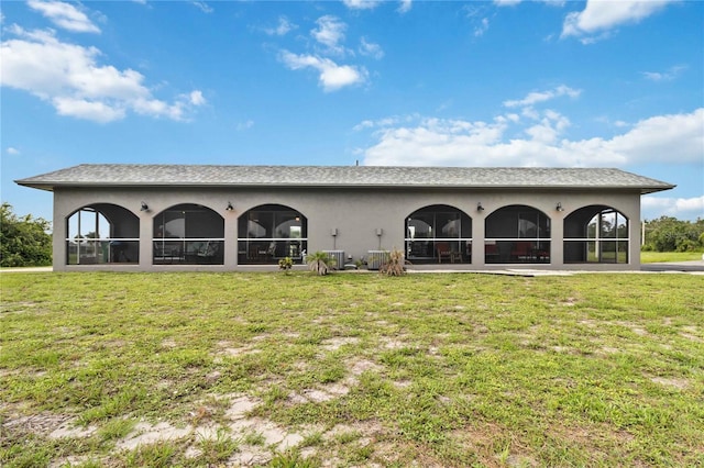 rear view of property with a yard