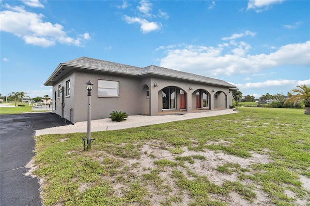 rear view of property with a lawn