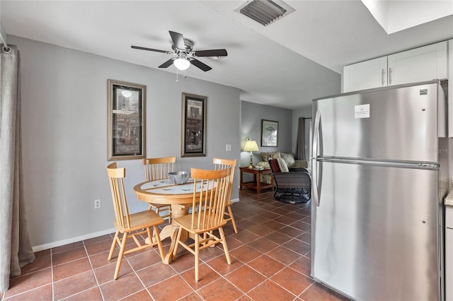 tiled dining room with ceiling fan