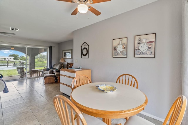 tiled dining area featuring ceiling fan