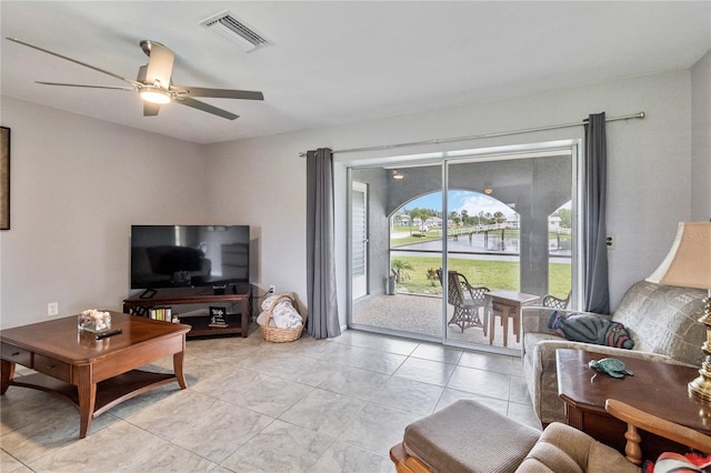 living room featuring ceiling fan and light tile patterned floors