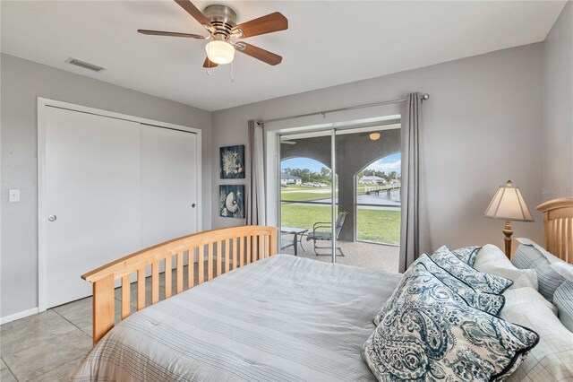 bedroom with ceiling fan, a closet, and light tile patterned flooring