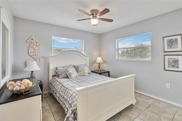 bedroom with ceiling fan and light tile patterned floors