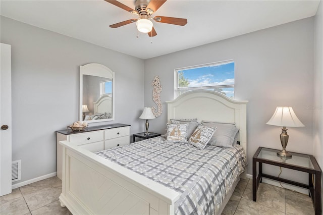 tiled bedroom featuring ceiling fan