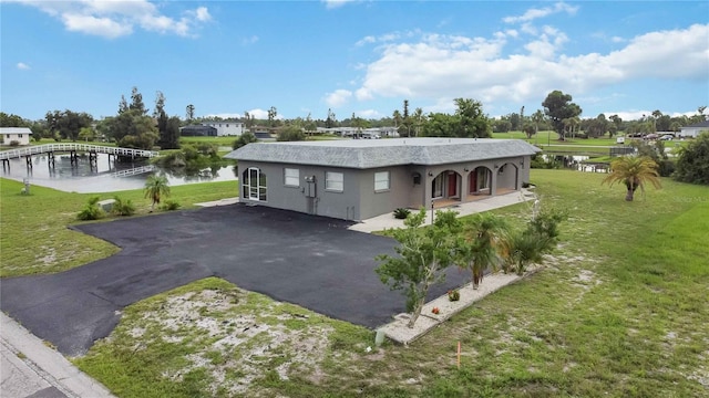 exterior space with a water view and a lawn