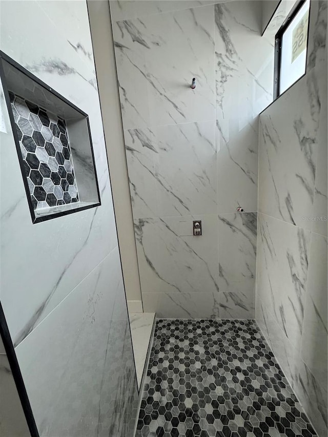 bathroom with tiled shower