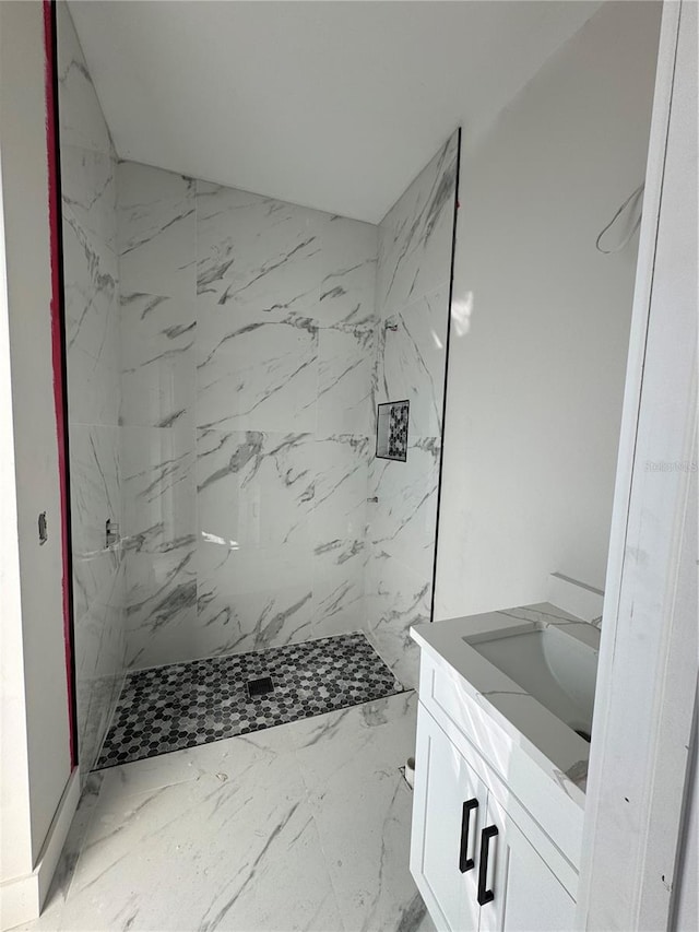 bathroom featuring vanity and tiled shower