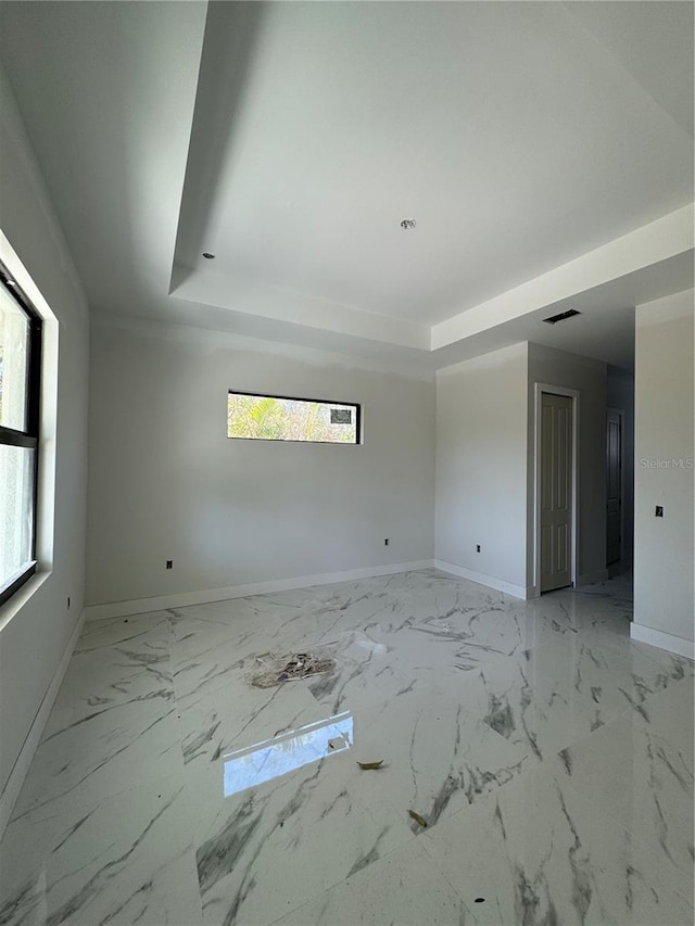 spare room featuring a tray ceiling