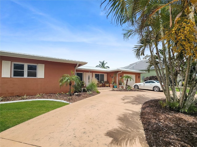 view of front of property with concrete driveway and stucco siding