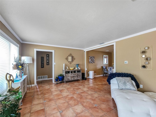 living room featuring tile patterned flooring, visible vents, and ornamental molding