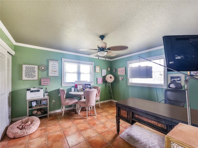 tiled office space with a textured ceiling, ceiling fan, ornamental molding, and baseboards