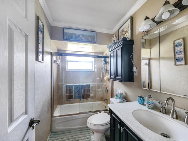 full bathroom with ornamental molding, toilet, vanity, and bath / shower combo with glass door