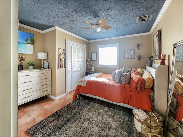 tiled bedroom with visible vents, ornamental molding, and a textured ceiling